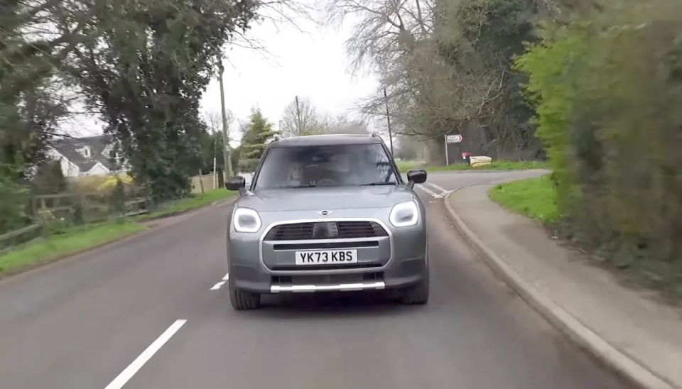 O fotografie cu un MINI Countryman în timp ce circulă pe un drum